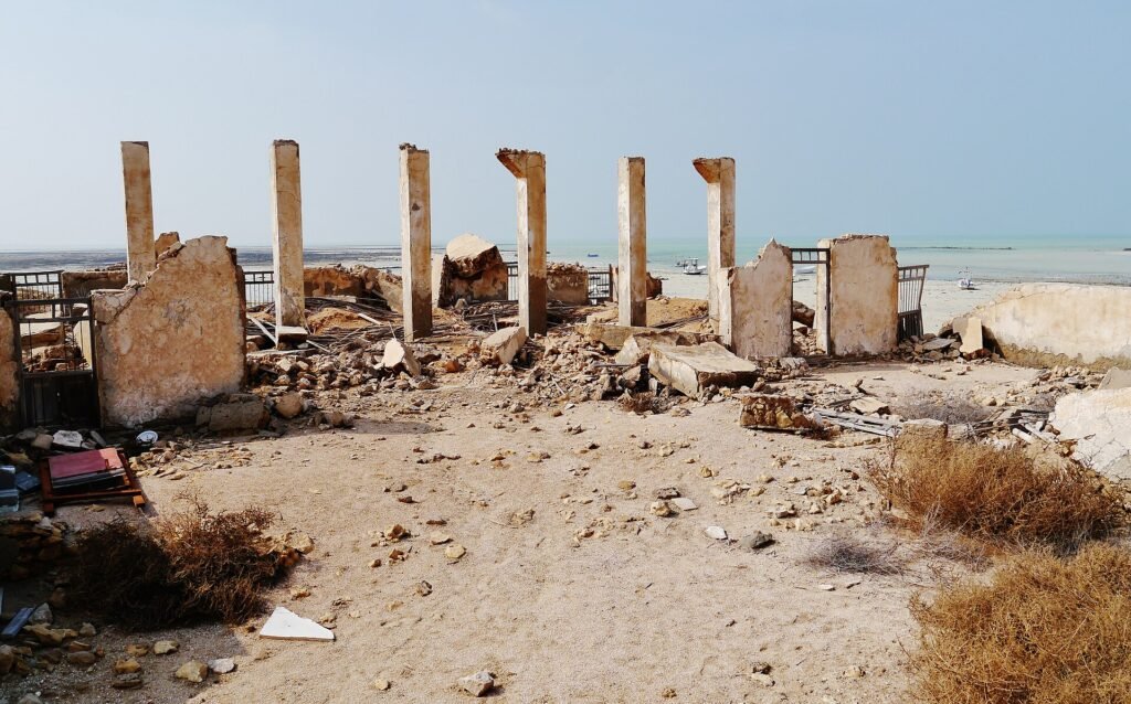 A line of free-standing stone pillars among the ruins of Al Khuwayr