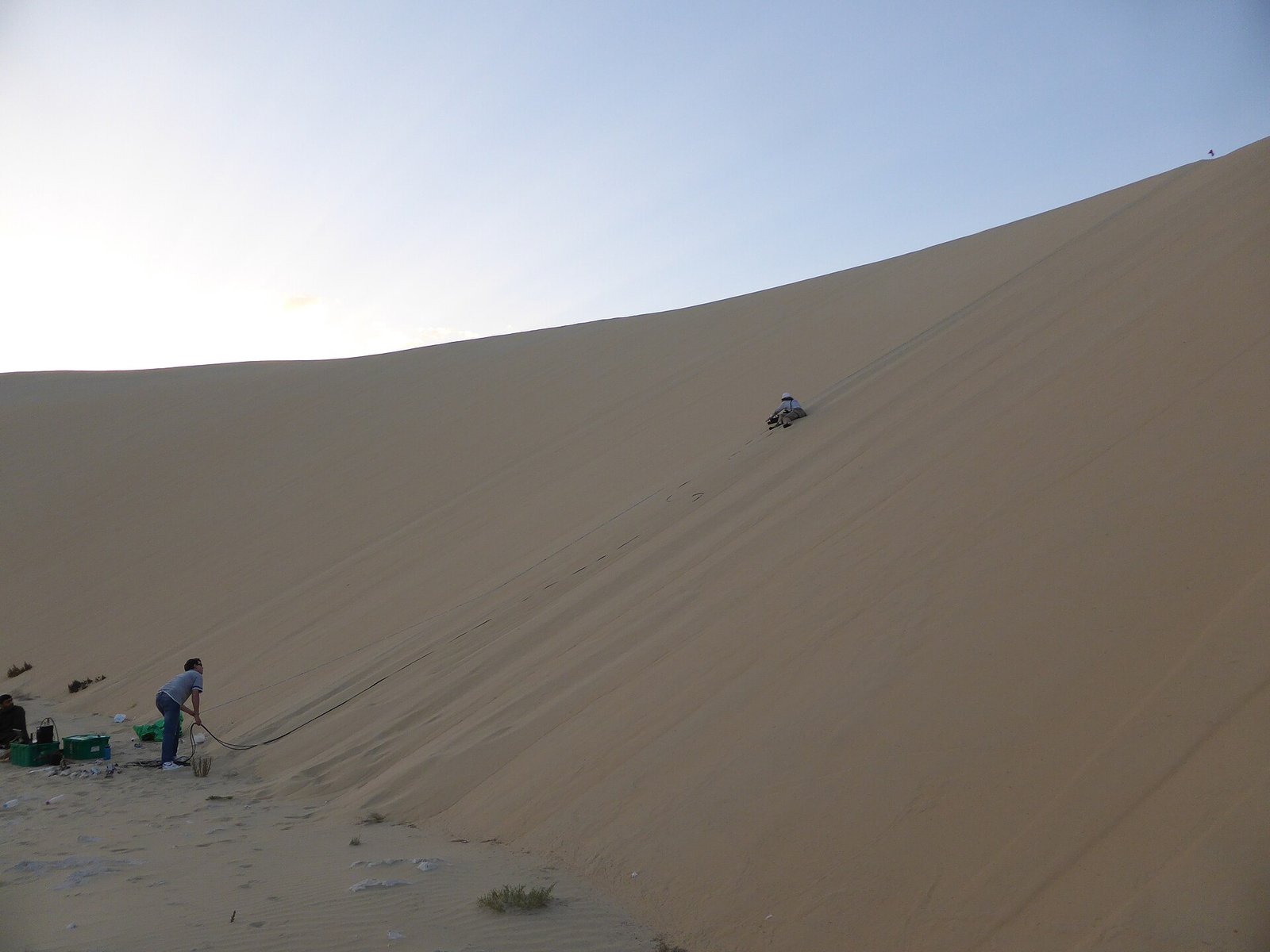 Vehicle on a large sand dune in Qatar in late afternoon light