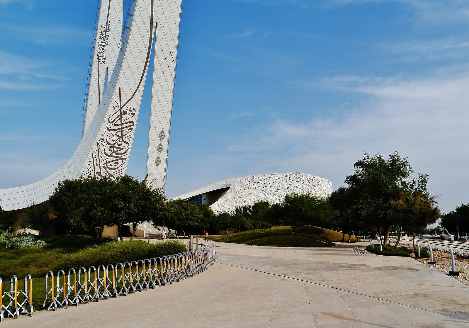 The twin calligraphy-covered minarets and patterned shell of the Minaretein building in Education City