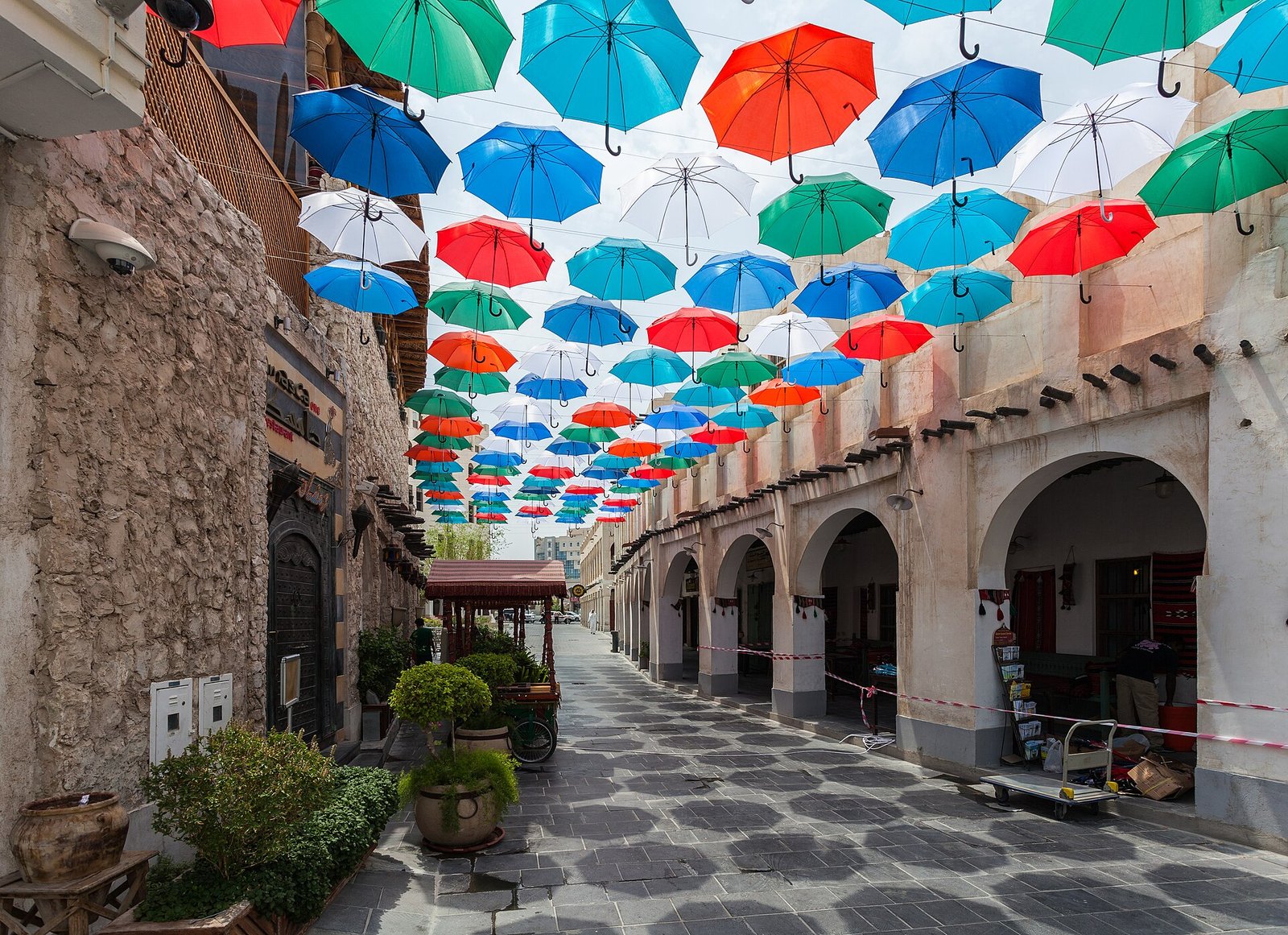Colourful umbrellas shading a lane in Souq Waqif, Doha