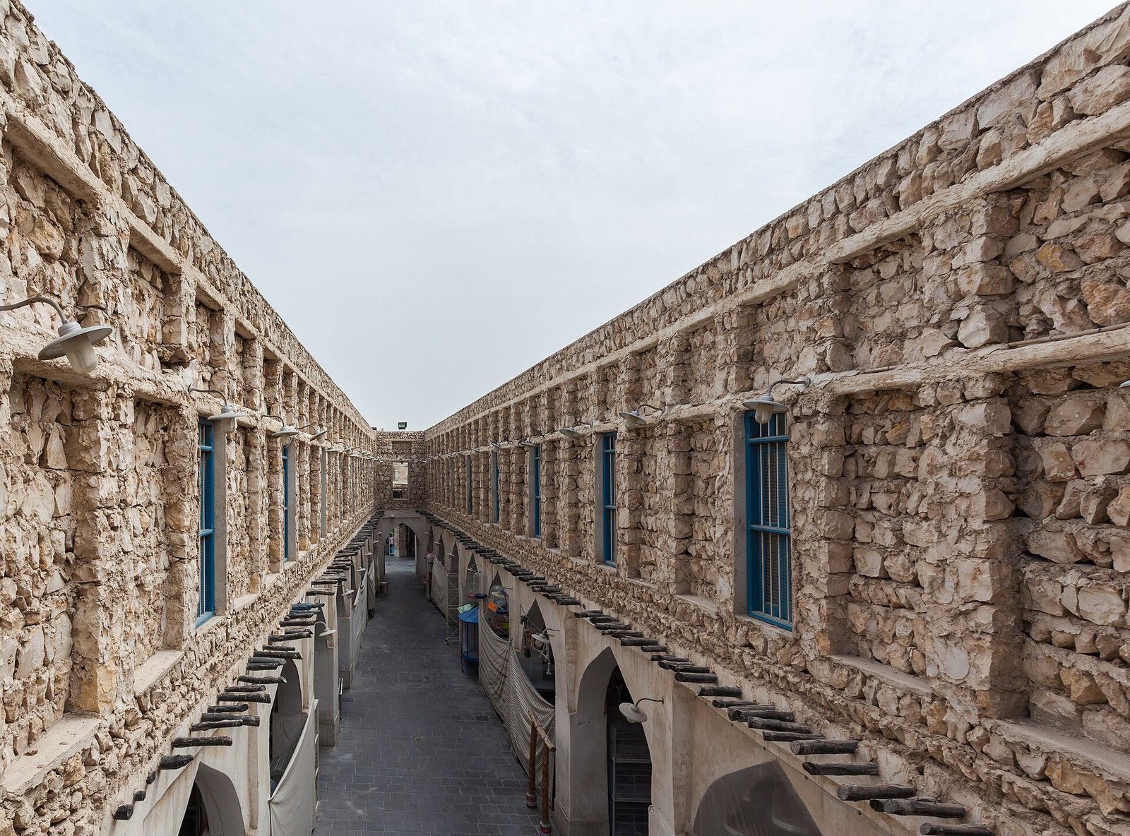 A narrow stone lane between restored buildings in Souq Waqif, Doha