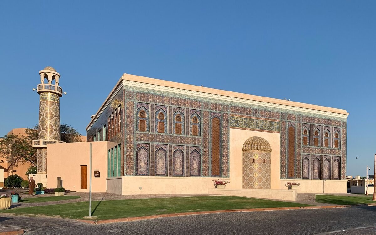The blue-tiled facade of Katara Mosque, decorated with turquoise and gold tilework