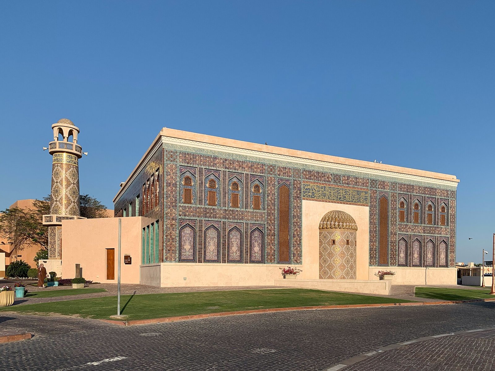 The blue-tiled facade of Katara Mosque, decorated with turquoise and gold tilework