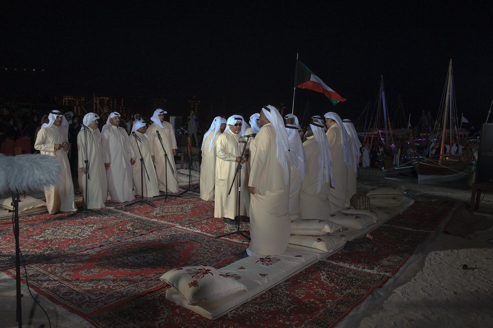 Kuwaiti performers in traditional dress singing at the Katara Traditional Dhow Festival