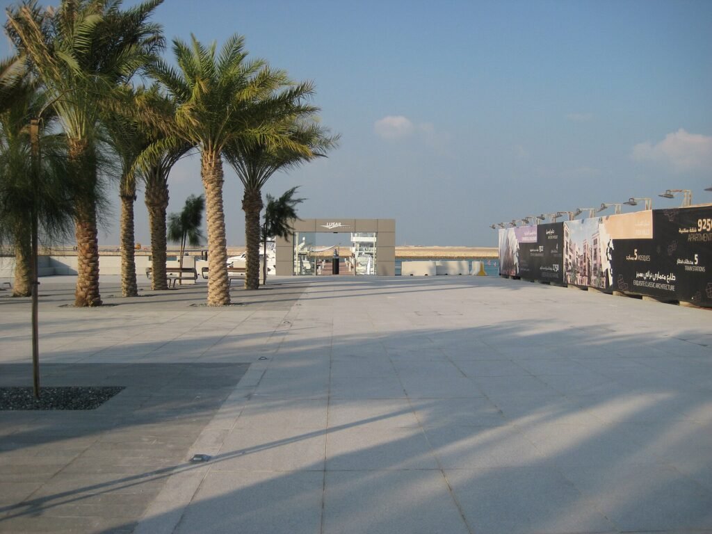 Palm-lined paved promenade along Lusail Marina