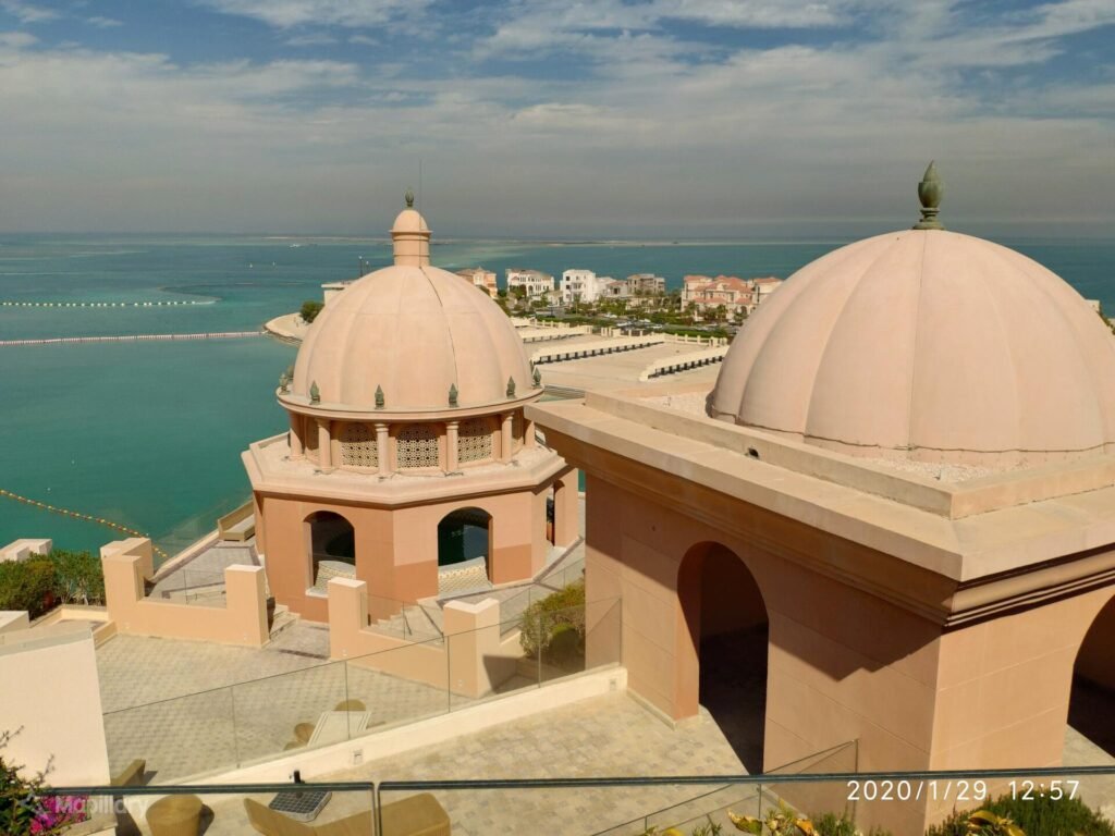 Domed rooftops of Marsa Malaz Kempinski with The Pearl and the Gulf beyond