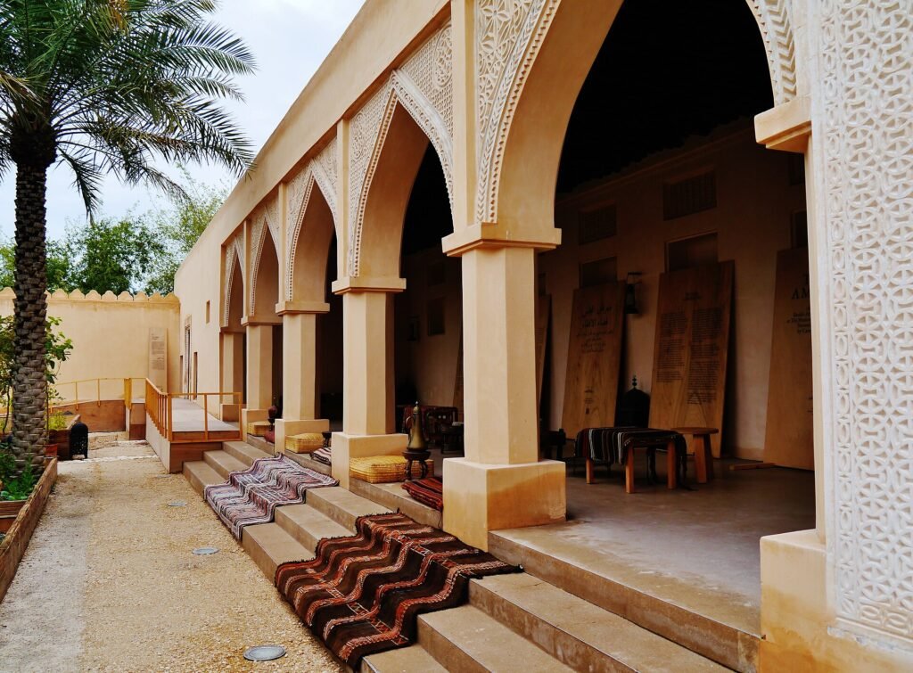 Shaded arcade with carpets and cushions in the Old Palace courtyard