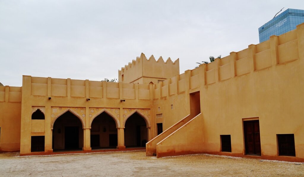 Crenellated walls and arched openings of the Old Palace complex in Doha
