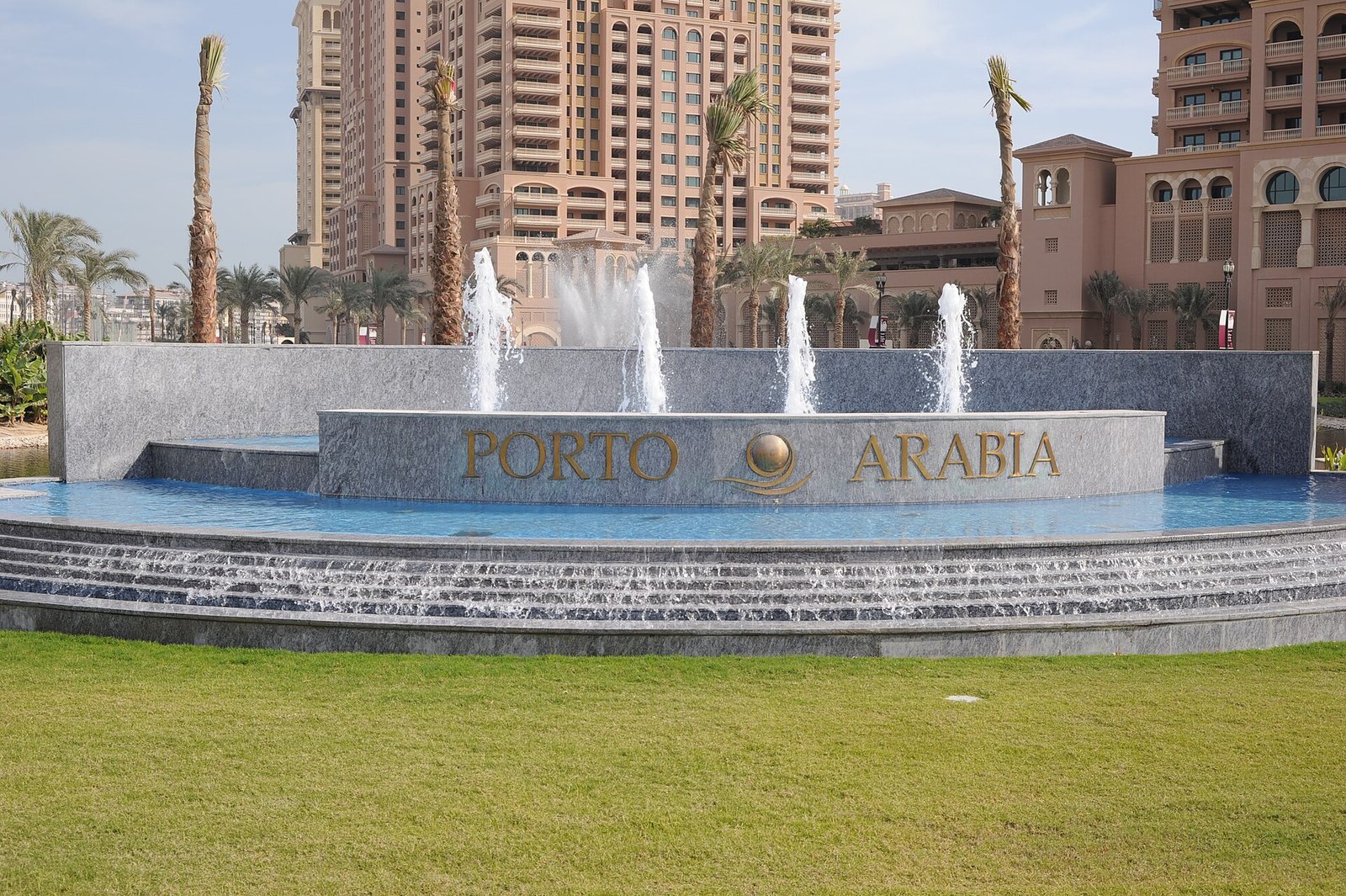 Porto Arabia sign and fountain at the entrance to the district