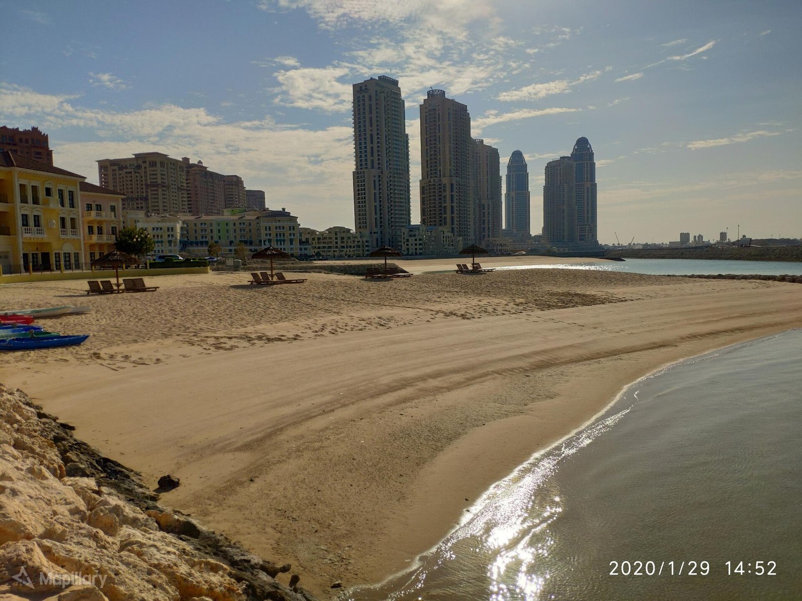 Quiet sandy beach at Qanat Quartier on The Pearl-Qatar with West Bay towers behind