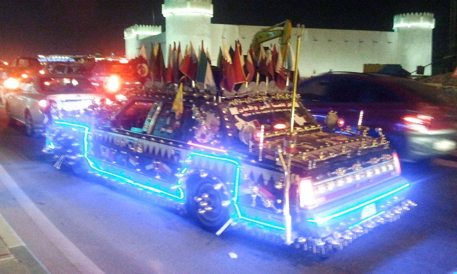 A car decorated with Qatari flags and lights during National Day celebrations in Doha
