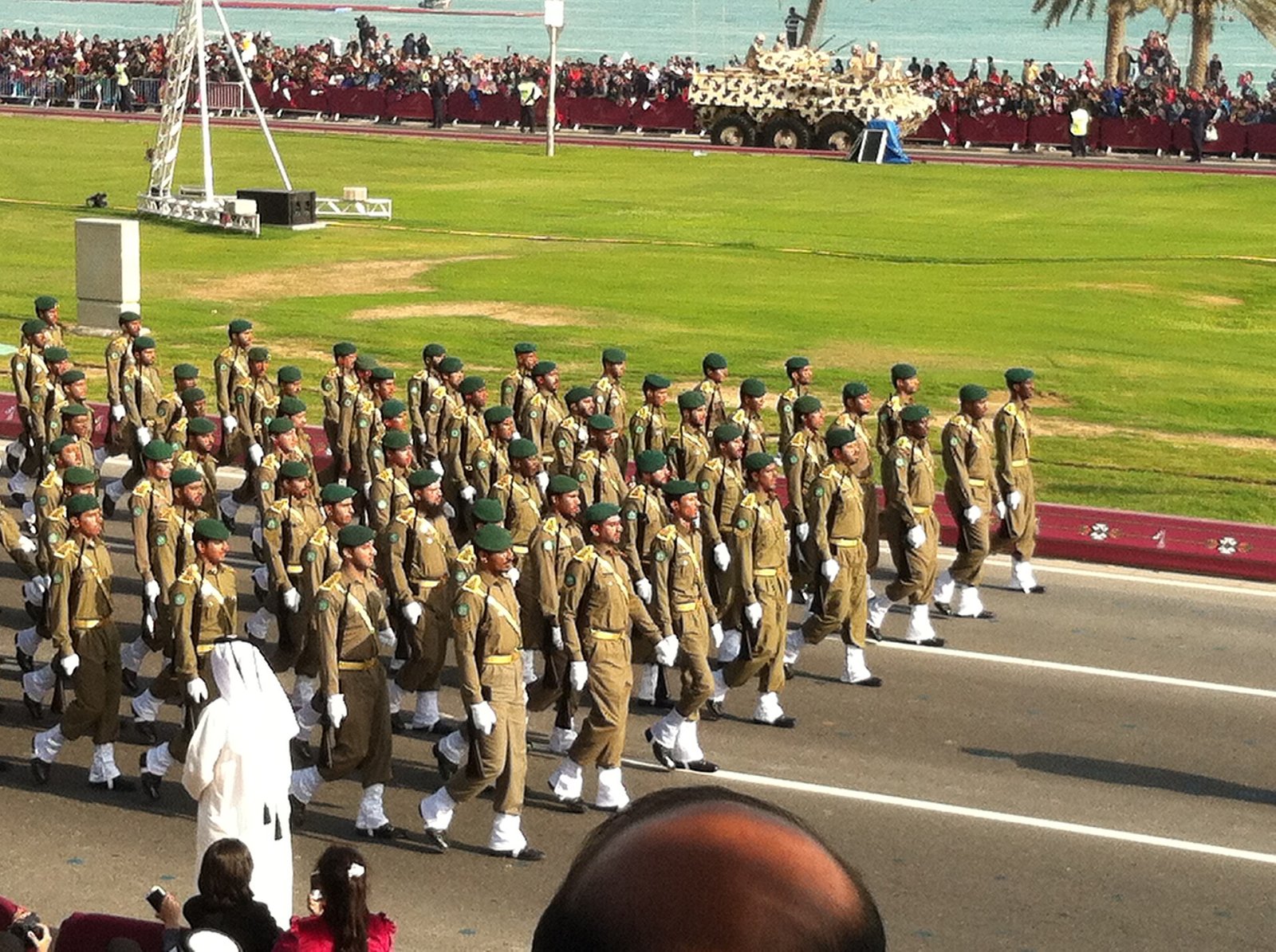 Qatari soldiers marching down the Doha Corniche during the National Day parade