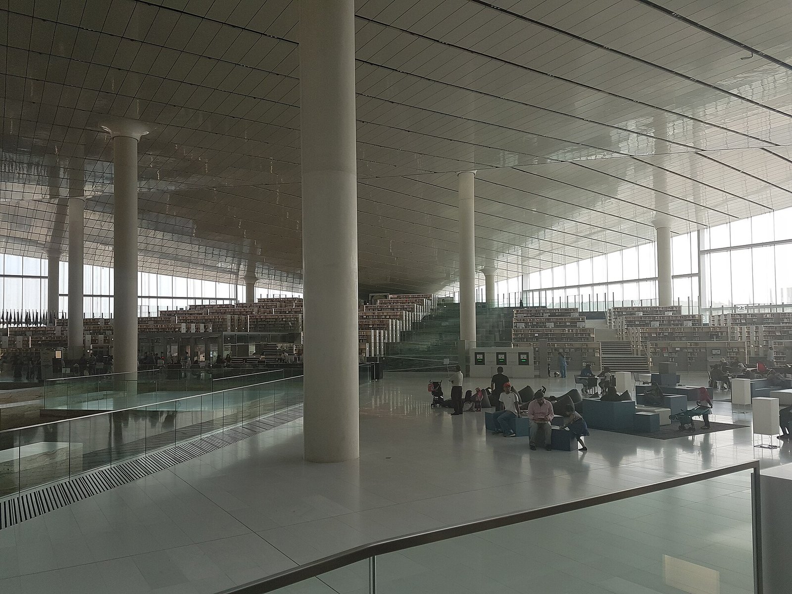 The open main hall of Qatar National Library with its slim columns and glass walls