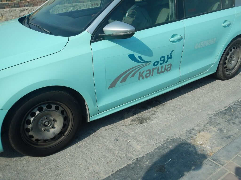 Turquoise Karwa taxi parked in Doha