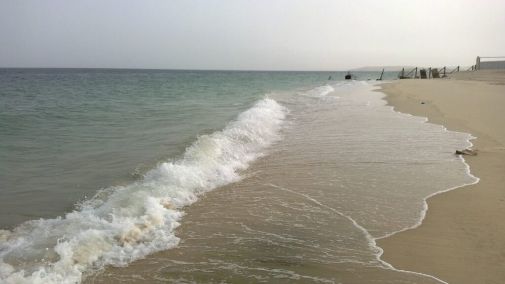 Waves breaking on the sandy shore at Sealine Beach, Mesaieed