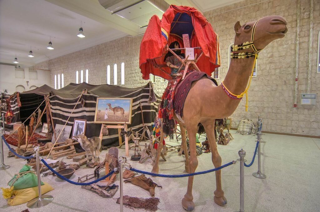 Camel carriage and heritage exhibits in a gallery at the Sheikh Faisal Museum