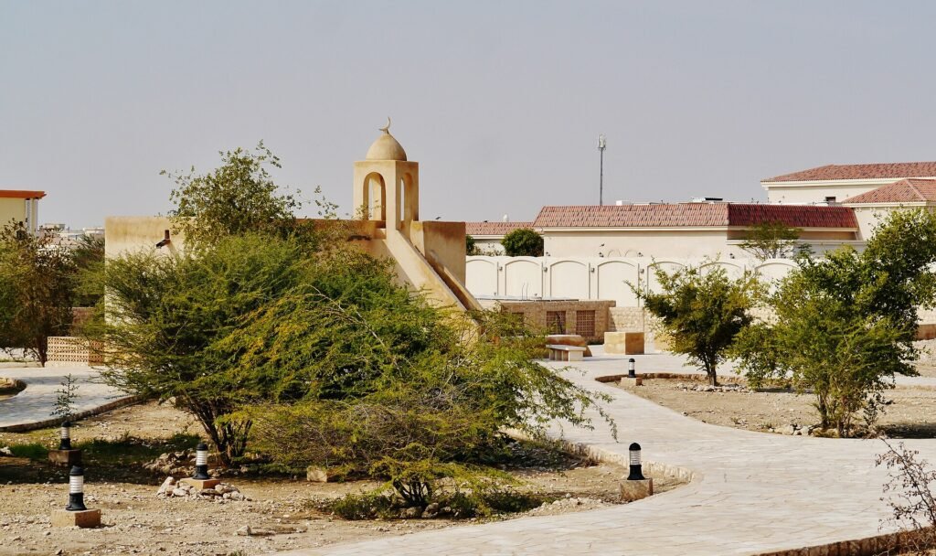 Garden paths and a small domed structure in the restored grounds at Umm Salal Mohammed