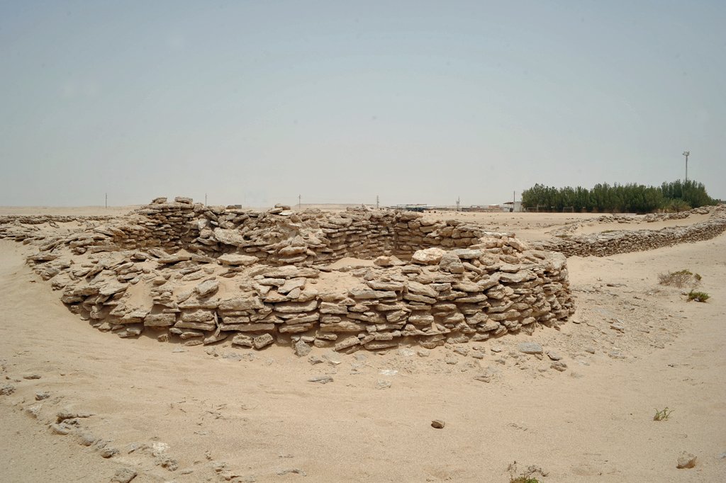 Rounded rubble-stone corner tower of Zekreet Fort in the desert