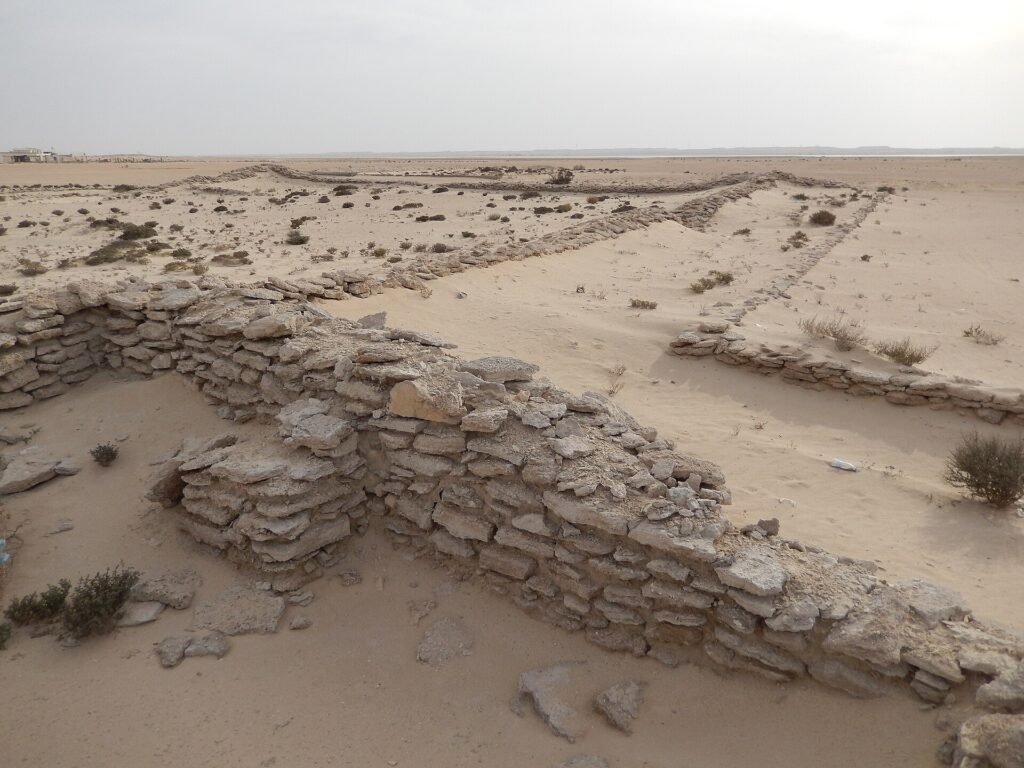 Close view of the rough beach-rock walls inside the ruined Zekreet Fort