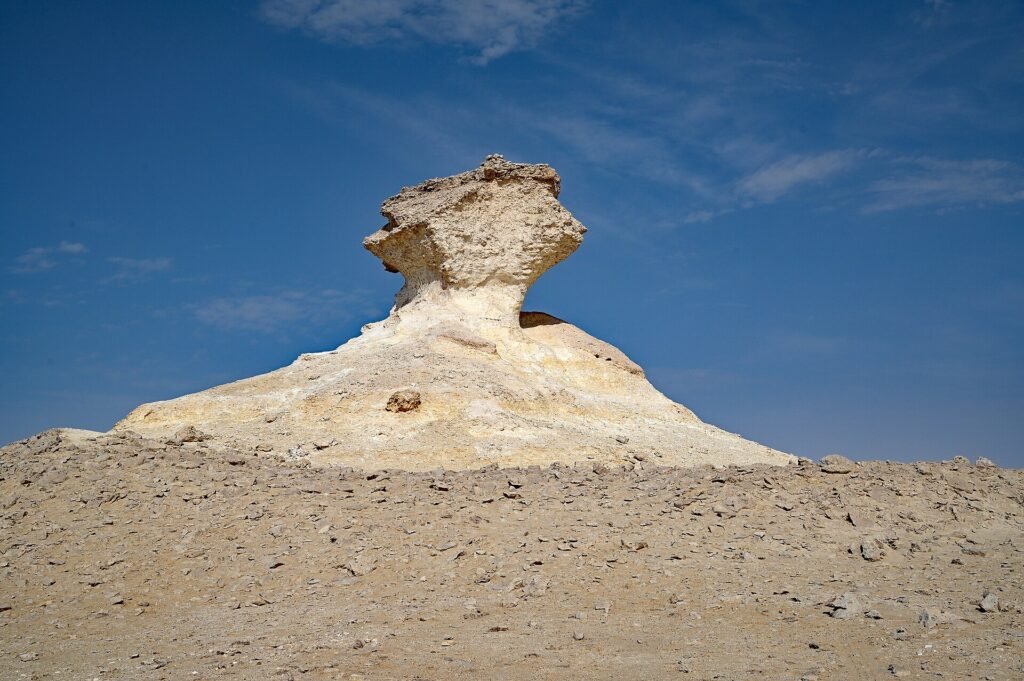 Mushroom-shaped limestone pillar rising from the desert plain at Zekreet