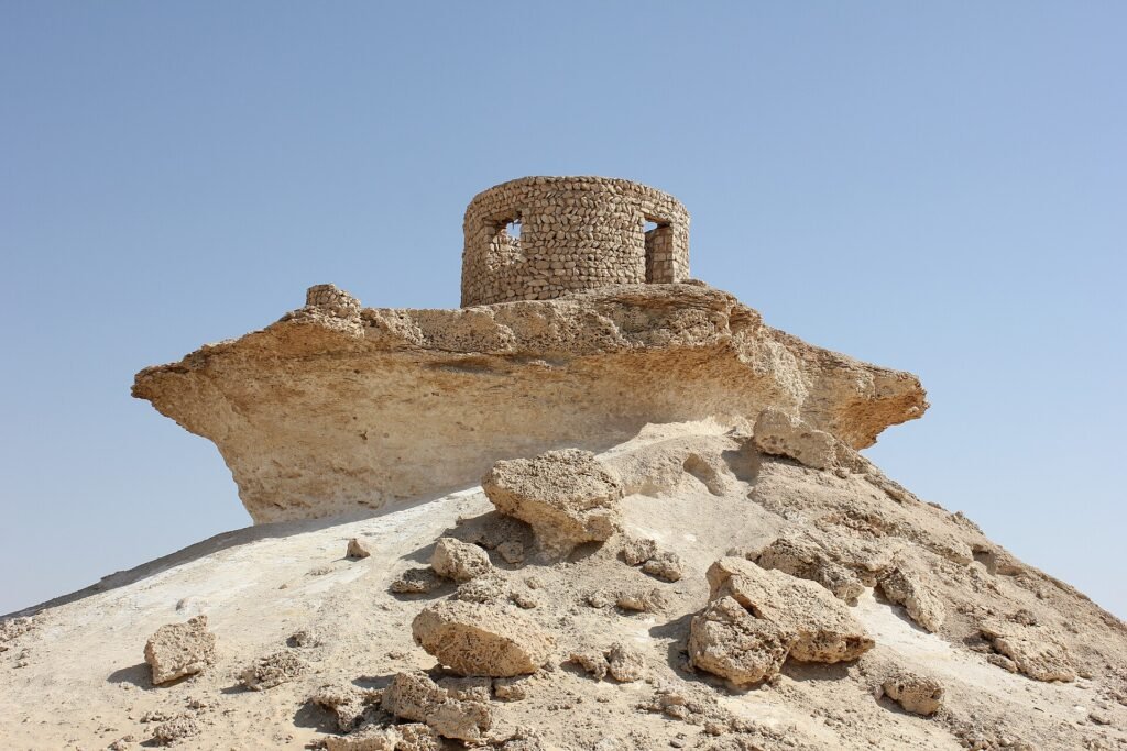 Round stone hut built on top of a limestone pillar near Film City, Zekreet